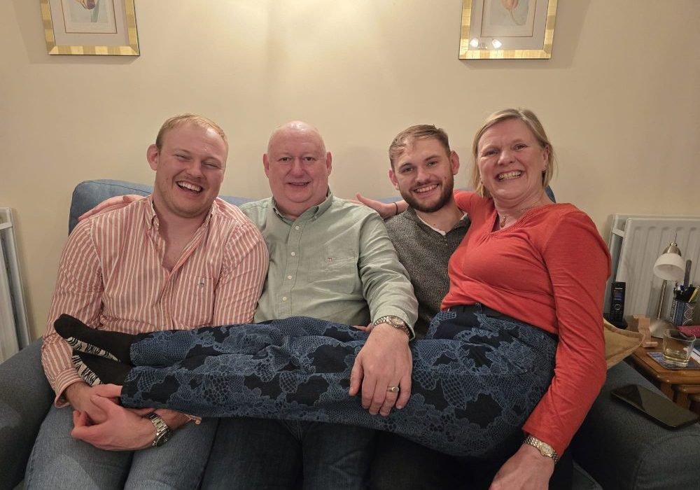 Chris Bosworth and family 2 Three males sat next to each other on the sofa, mum is sat with her legs across their knees