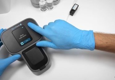 Microbiosensor pic_for web story Hands wearing blue latex gloves holding a Quick Check device