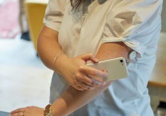 sweet-life-qQ1Z3GwW3cU-unsplash Young South African woman with Type 1 diabetes scanning blood glucose with a flash glucose monitor.