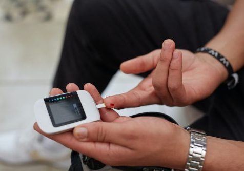 sweet-life-SBtNby0IiG0-unsplash A young South African man with diabetes demonstrating blood glucose testing using gluco-meter.