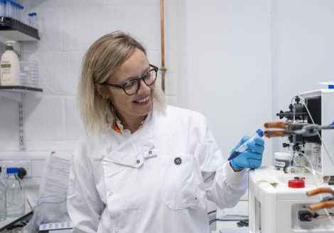 UofE_034_DialysisProject Female with blonde hair, in a white lab coat and round black glasses in a research lab