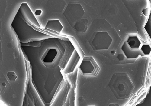 scientific image Close-up view of snowflake structures showing hexagonal shapes and intricate details.